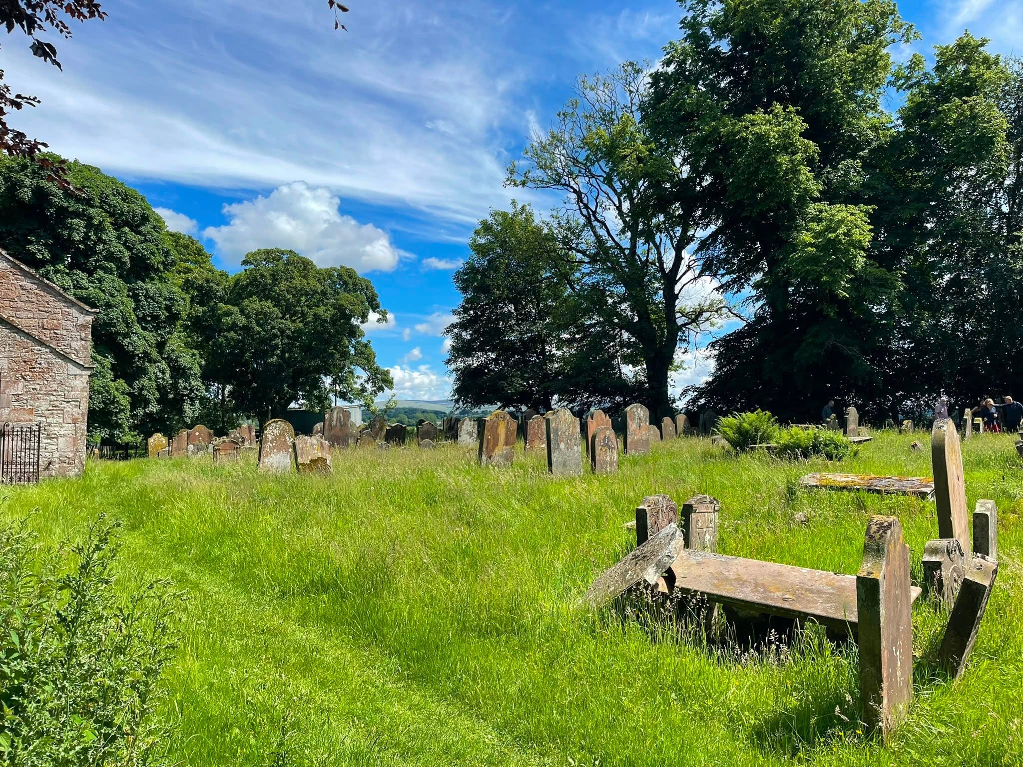 Historic gravestones in the churchyard at Brampton Old Church, Cumbria
