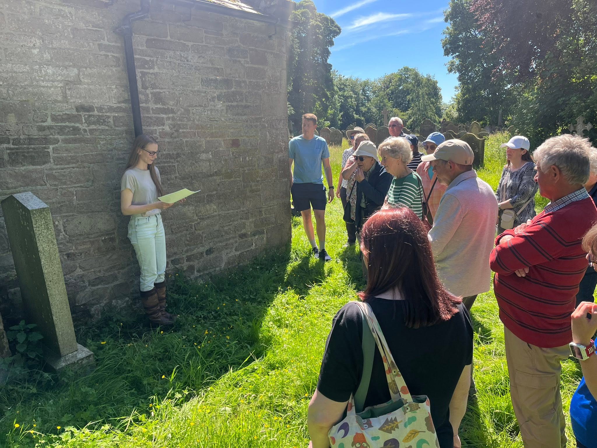 Visitors listening to Brittany Warren during a graveyard tour at Brampton Old Church
